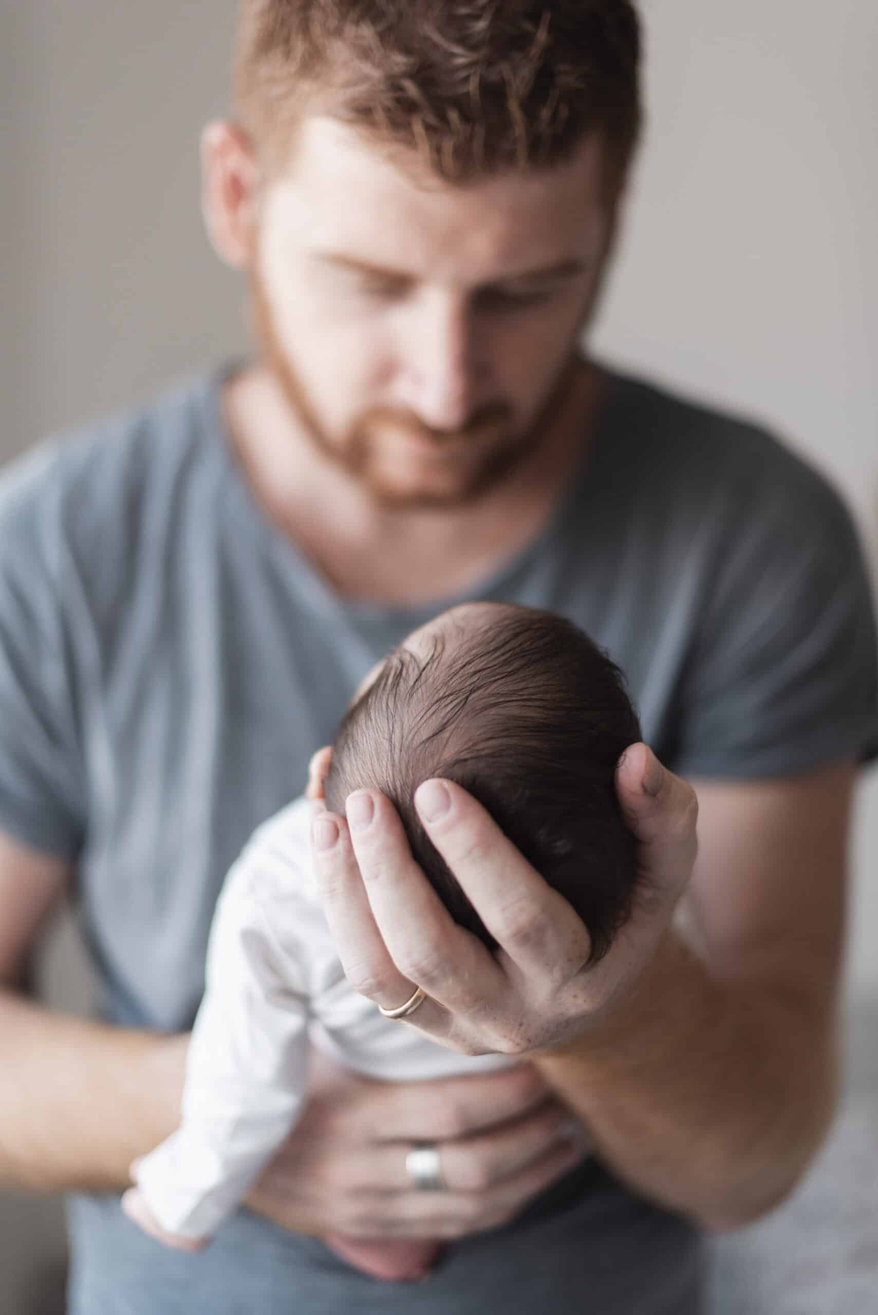 medium-shot-blurred-father-holding-baby